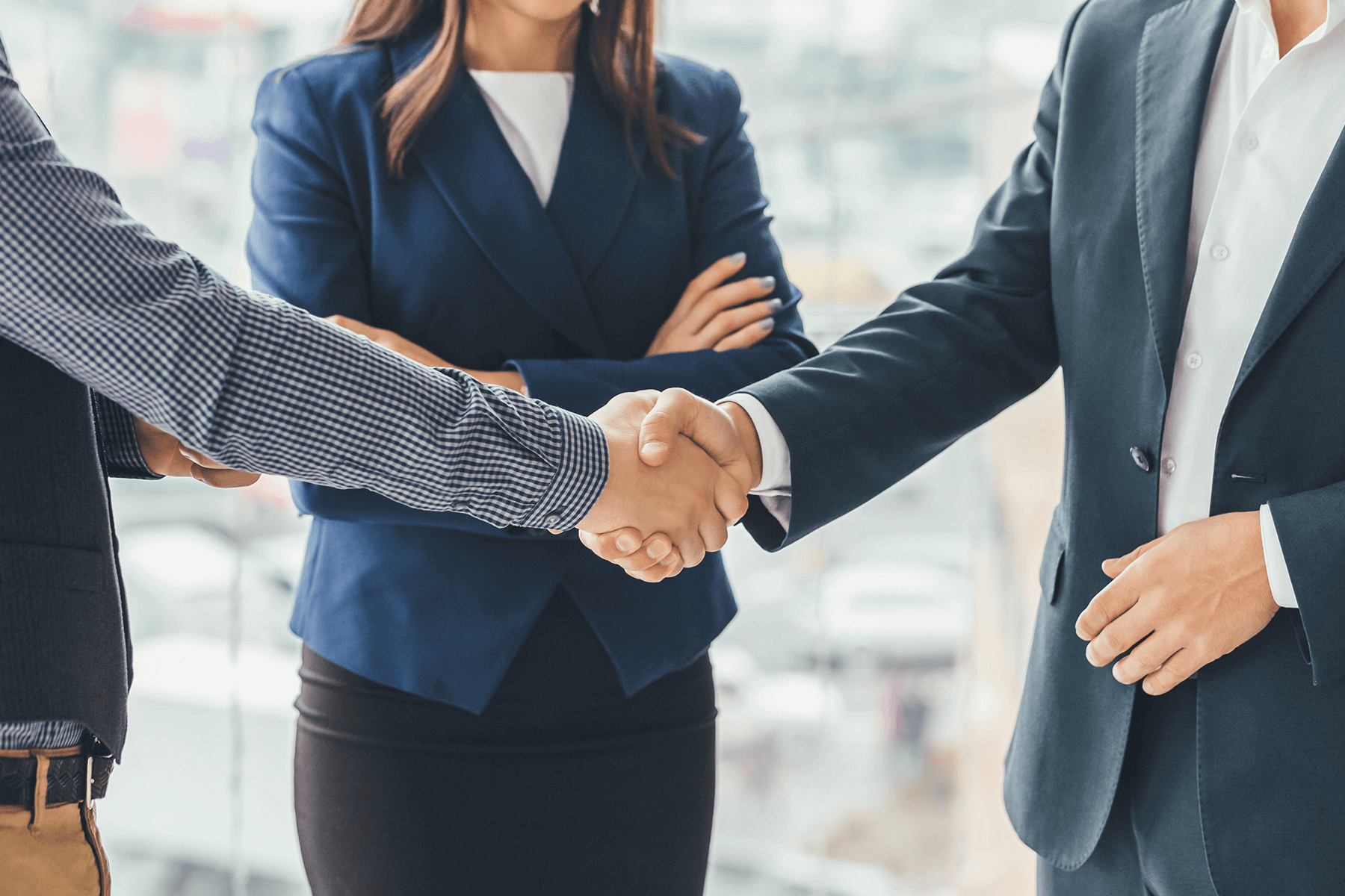 employees in smart clothing shaking hands